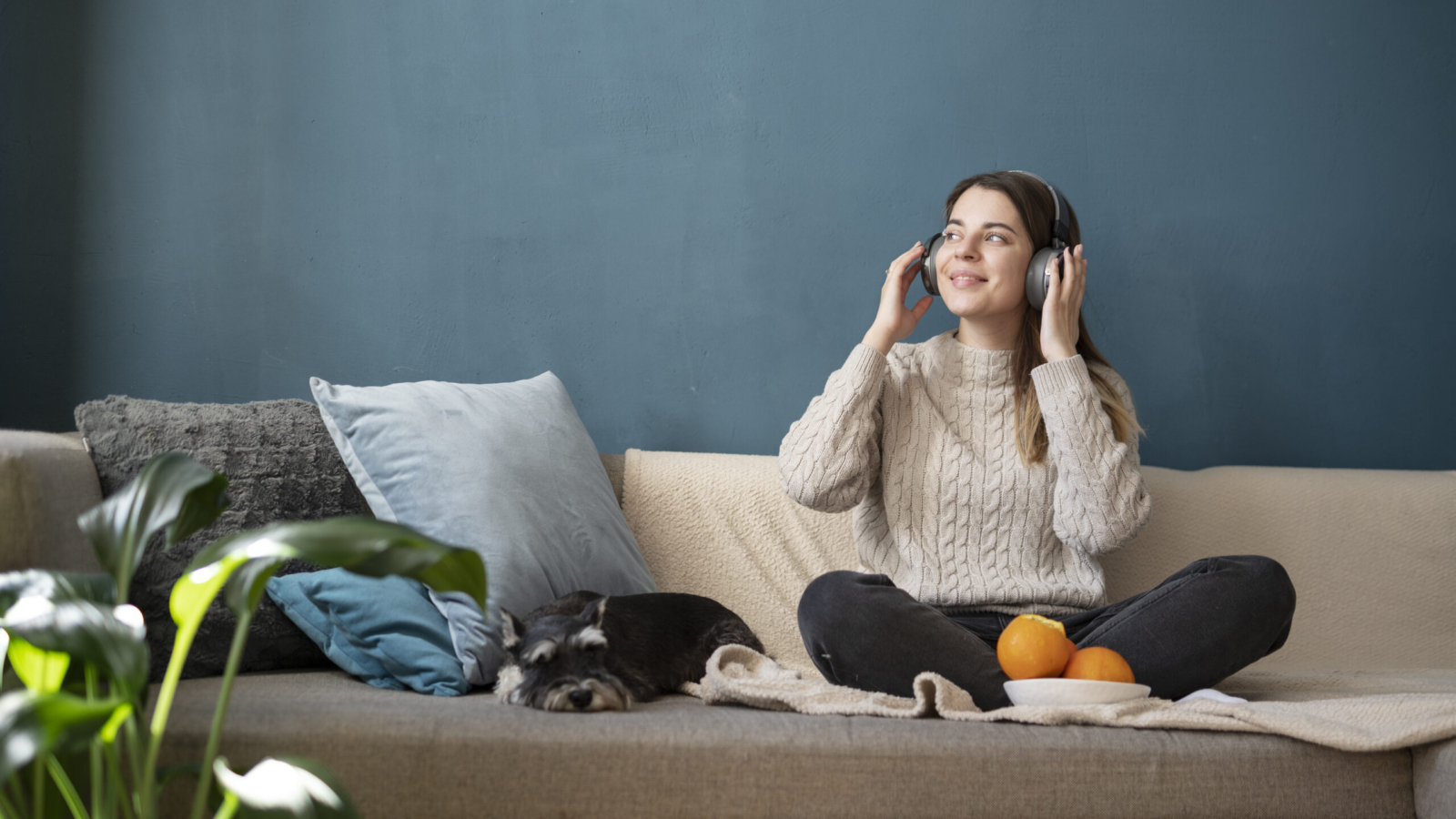 young-woman-using-headphones-sofa