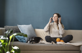 young-woman-using-headphones-sofa