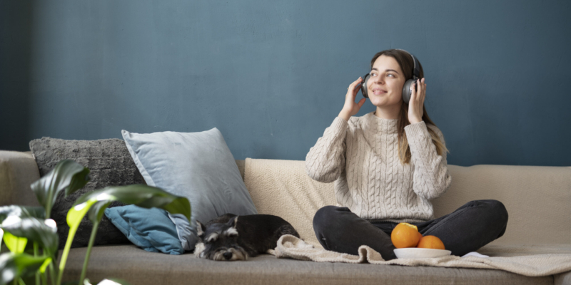 young-woman-using-headphones-sofa