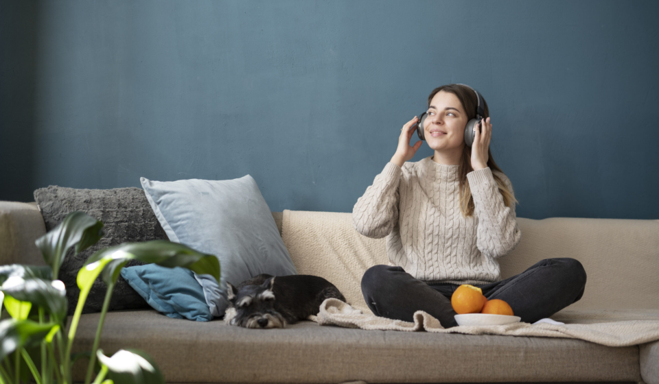 young-woman-using-headphones-sofa